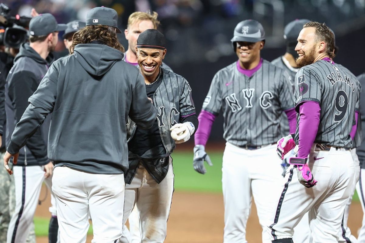 Apr 5, 2025; New York City, New York, USA;  New York Mets shortstop Francisco Lindor (12) celebrates with his teammates after hitting a game winning sacrifice fly in the ninth inning against the Toronto Blue Jays at Citi Field. Mandatory Credit: Wendell Cruz-Imagn Images