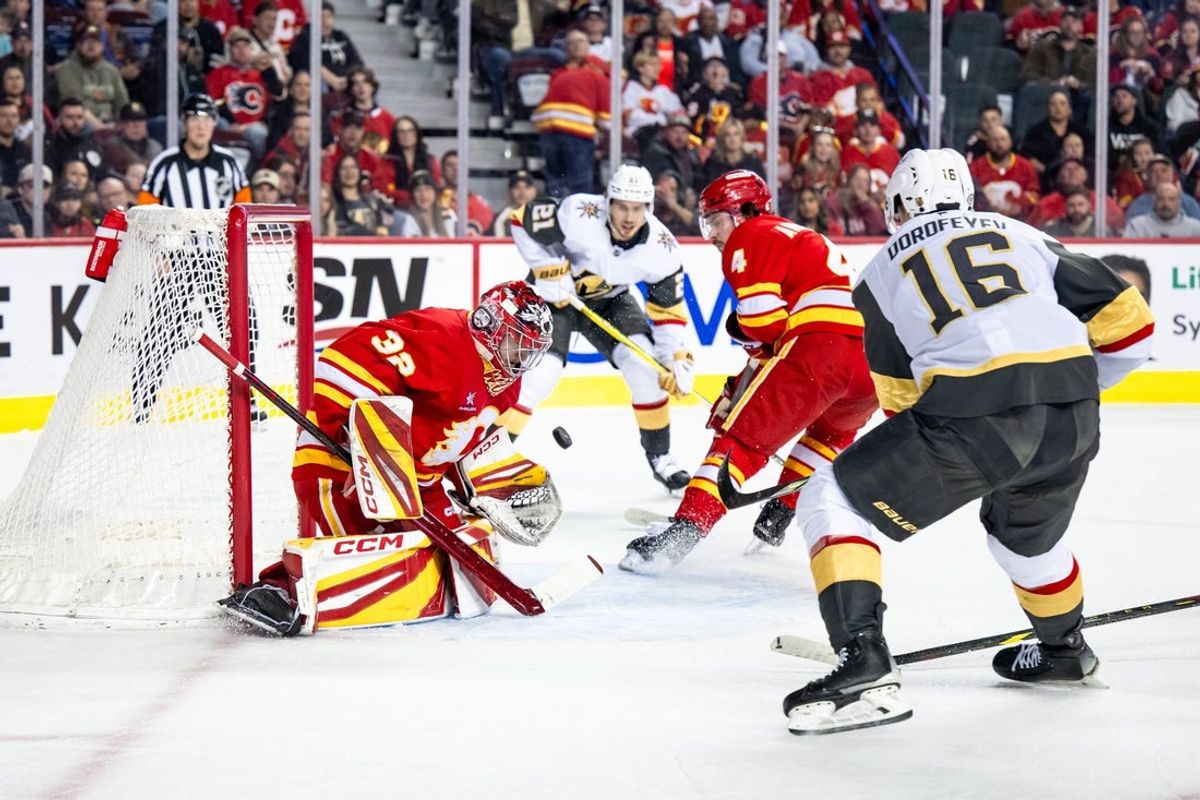 Apr 5, 2025; Calgary, Alberta, CAN; Vegas Golden Knights left wing Pavel Dorofeyev (16) scores a goal on Calgary Flames goaltender Dustin Wolf (32) during the first period at Scotiabank Saddledome. Mandatory Credit: Brett Holmes-Imagn Images