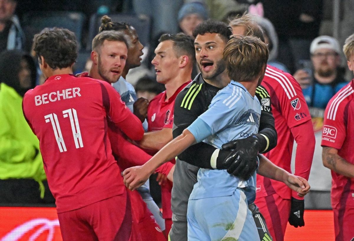 Apr 5, 2025; Kansas City, Kansas, USA;  Sporting Kansas City goalkeeper John Pulskamp (1) pulls teammate Jake Davis (17) away from St. Louis City forward Cedric Teuchert (36) at the end of the game at Children's Mercy Park. Mandatory Credit: Peter Aiken-Imagn Images