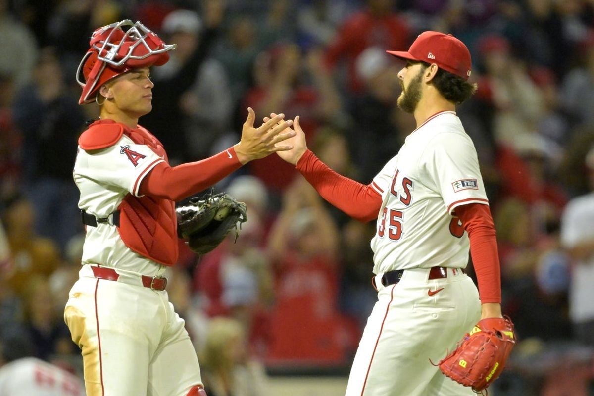 Apr 5, 2025; Anaheim, California, USA;  Los Angeles Angels catcher Logan O'Hoppe (14) shakes hands with relief pitcher Joey Cantillo (54) after the final out of the ninth inning against the Cleveland Guardians at Angel Stadium. Mandatory Credit: Jayne Kamin-Oncea-Imagn Images
