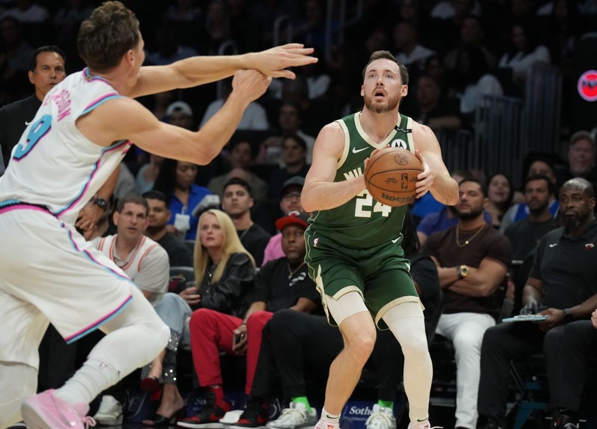 Apr 5, 2025; Miami, Florida, USA;  Milwaukee Bucks guard Pat Connaughton (24) takes a shot as Miami Heat guard Pelle Larsson (9) defends during the second half at Kaseya Center. Mandatory Credit: Jim Rassol-Imagn Images