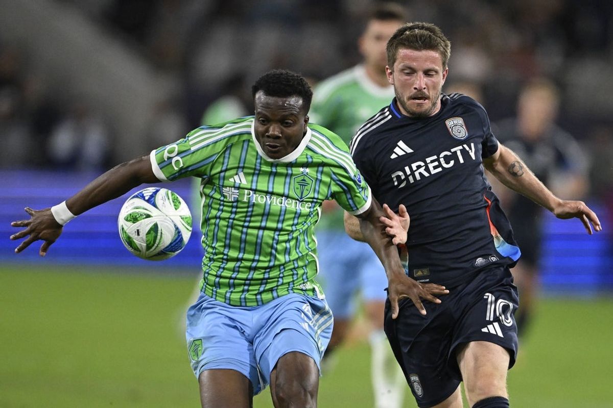 Apr 5, 2025; San Diego, California, USA; Seattle Sounders defender Nouhou Tolo (5) and San Diego FC midfielder Anders Dreyer (10) fight for the ball at Snapdragon Stadium. Mandatory Credit: Denis Poroy-Imagn Images