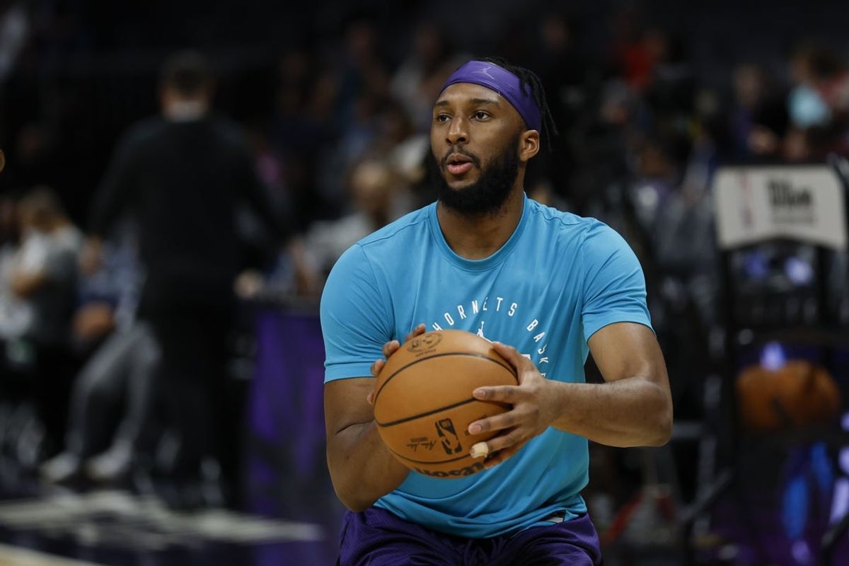 Apr 6, 2025; Charlotte, North Carolina, USA; Charlotte Hornets forward Josh Okogie (12) shoots before a game against the Chicago Bulls at Spectrum Center. Mandatory Credit: Nell Redmond-Imagn Images