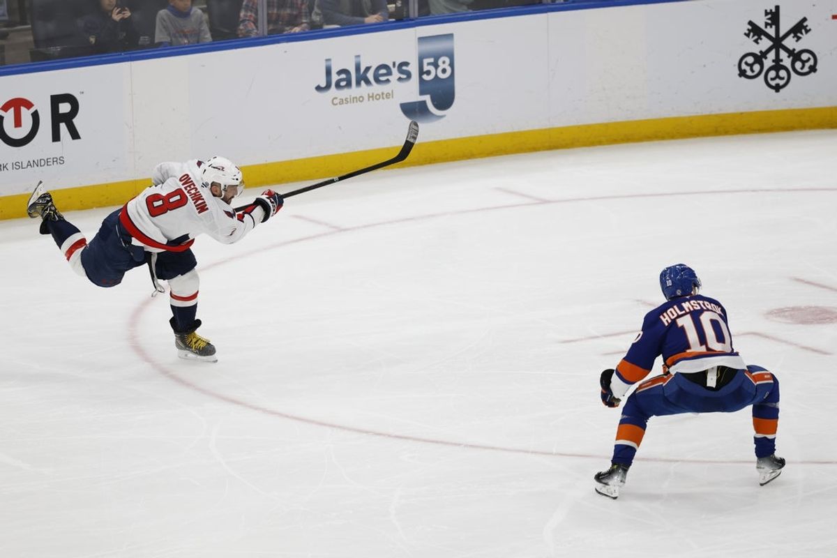 Apr 6, 2025; Elmont, New York, USA;  Washington Capitals left wing Alex Ovechkin (8) scores a goal in the 2nd period against the New York Islanders at UBS Arena. The goal is the 895th of Ovechkin’s career, breaking the NHL all-time career goals record previously held by Wayne Gretzky.at UBS Arena. Mandatory Credit: Geoff Burke-Imagn Images