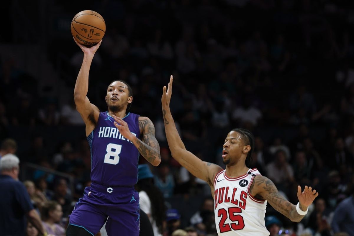 Apr 6, 2025; Charlotte, North Carolina, USA; Charlotte Hornets guard Nick Smith Jr. (8) shoots against Chicago Bulls forward Dalen Terry (25) during the first quarter at Spectrum Center. Mandatory Credit: Nell Redmond-Imagn Images