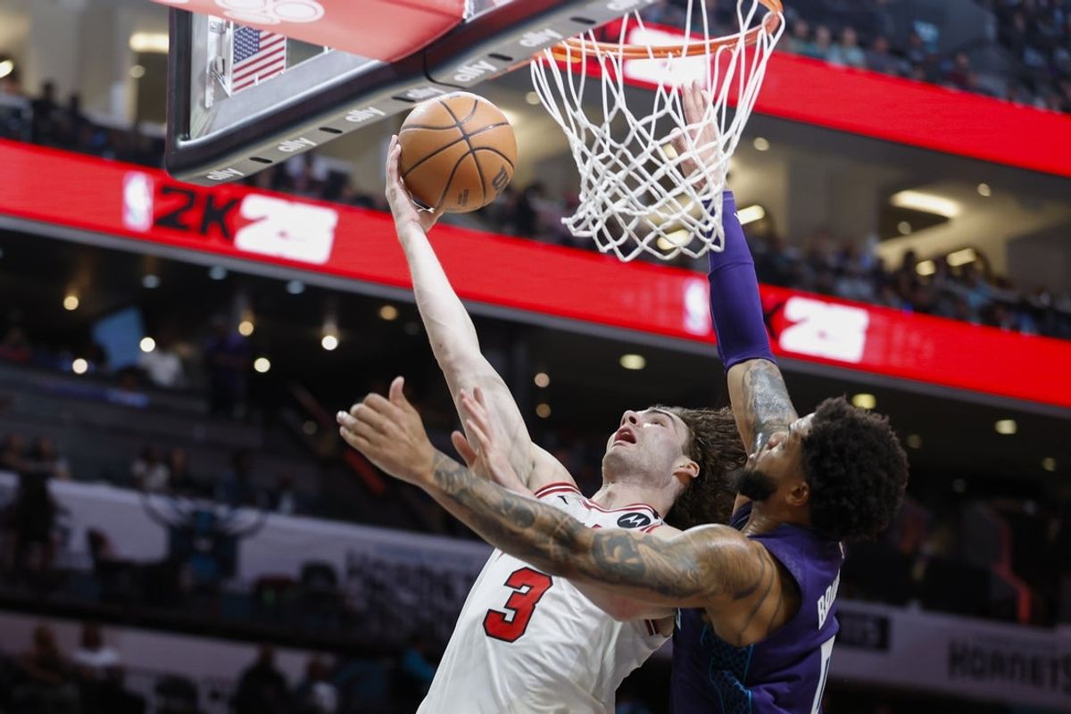 Apr 6, 2025; Charlotte, North Carolina, USA; Chicago Bulls guard Josh Giddey (3) drives to the basket against Charlotte Hornets forward Miles Bridges (0) during the second half at Spectrum Center. Mandatory Credit: Nell Redmond-Imagn Images