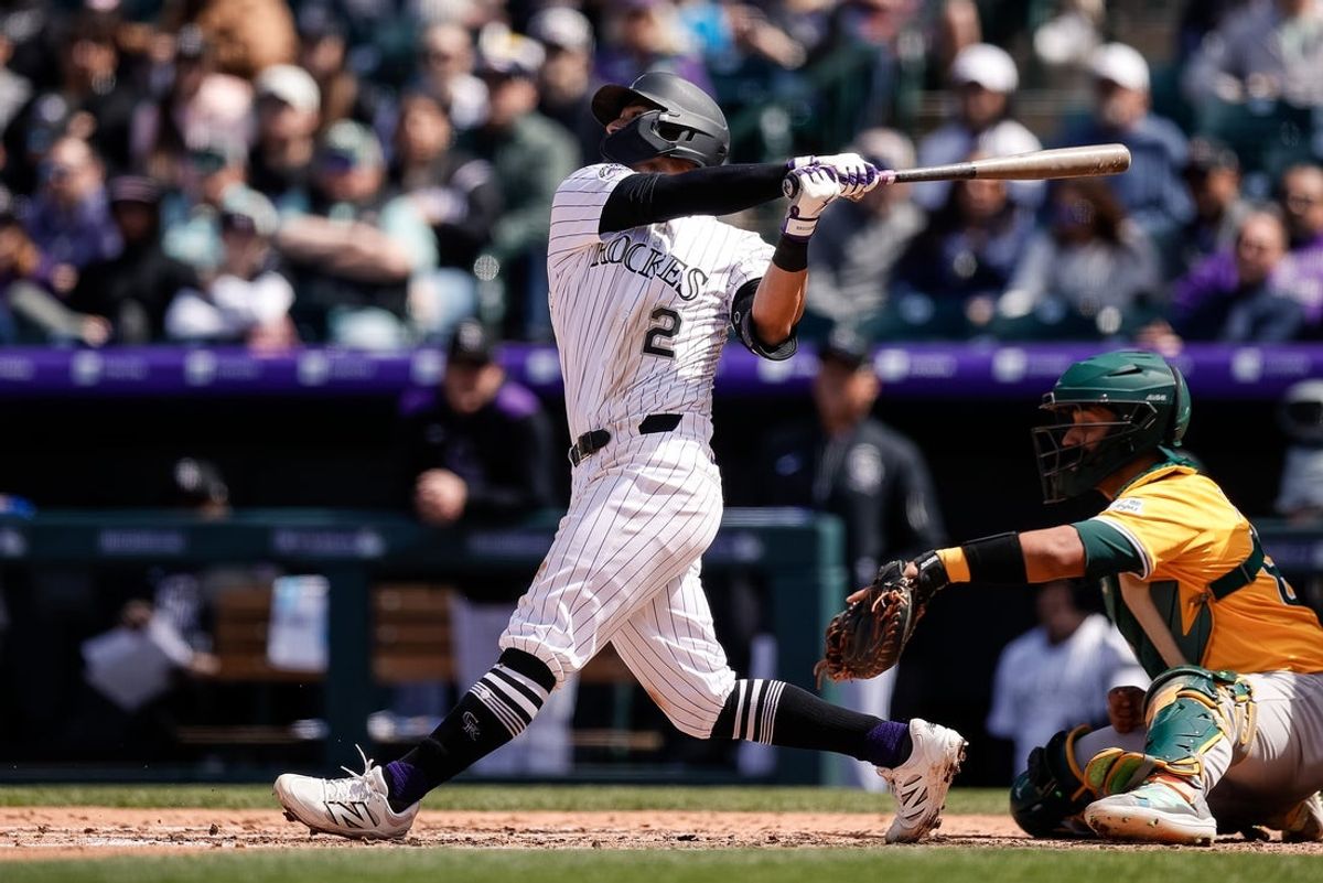 Apr 6, 2025; Denver, Colorado, USA; Colorado Rockies second baseman Tyler Freeman (2) watches his ball on a sacrifice fly RBI in the third inning against the Athletics at Coors Field. Mandatory Credit: Isaiah J. Downing-Imagn Images