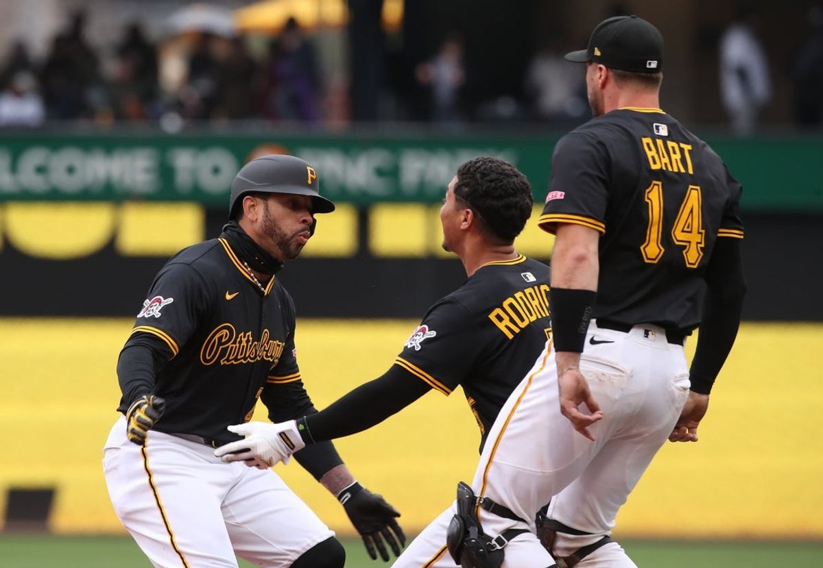 Apr 6, 2025; Pittsburgh, Pennsylvania, USA;  Pittsburgh Pirates catchers Endy Rodriguez and Joey Bart (14) congratulate left fielder Tommy Pham (28) after Pham hit a game winning RBI single to defeat the New York Yankees in the eleventh inning at PNC Park. Mandatory Credit: Charles LeClaire-Imagn Images
