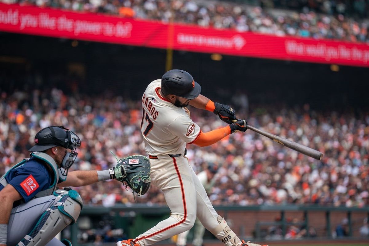 Apr 6, 2025; San Francisco, California, USA; San Francisco Giants designated hitter Heliot Ramos (17) hits a RBI single during the fourth inning against the Seattle Mariners at Oracle Park. Mandatory Credit: Neville E. Guard-Imagn Images