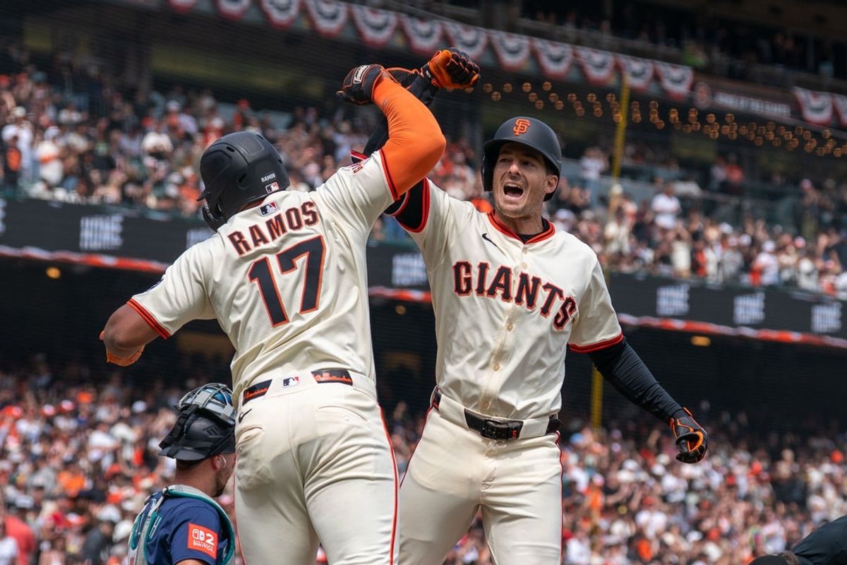 Apr 6, 2025; San Francisco, California, USA; San Francisco Giants designated hitter Heliot Ramos (17) gives for arm bashes toSan Francisco Giants right fielder Mike Yastrzemski (5) for the three run home against the Seattle Mariners during the fourth inning at Oracle Park. Mandatory Credit: Neville E. Guard-Imagn Images
