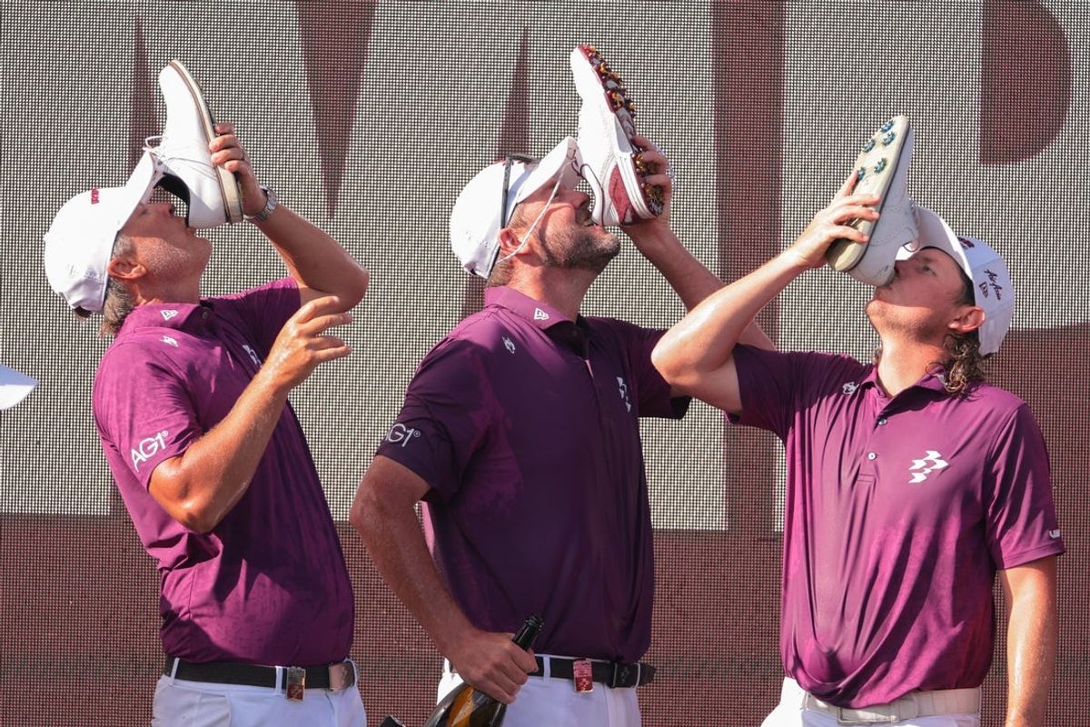 Apr 6, 2025; Miami, Florida, USA; Matt Jones, Marc Leishman, and Cameron Smith drinks from a shoe after winning the final round of the LIV Golf Miami golf tournament at Trump National Doral. Mandatory Credit: Sam Navarro-Imagn Images