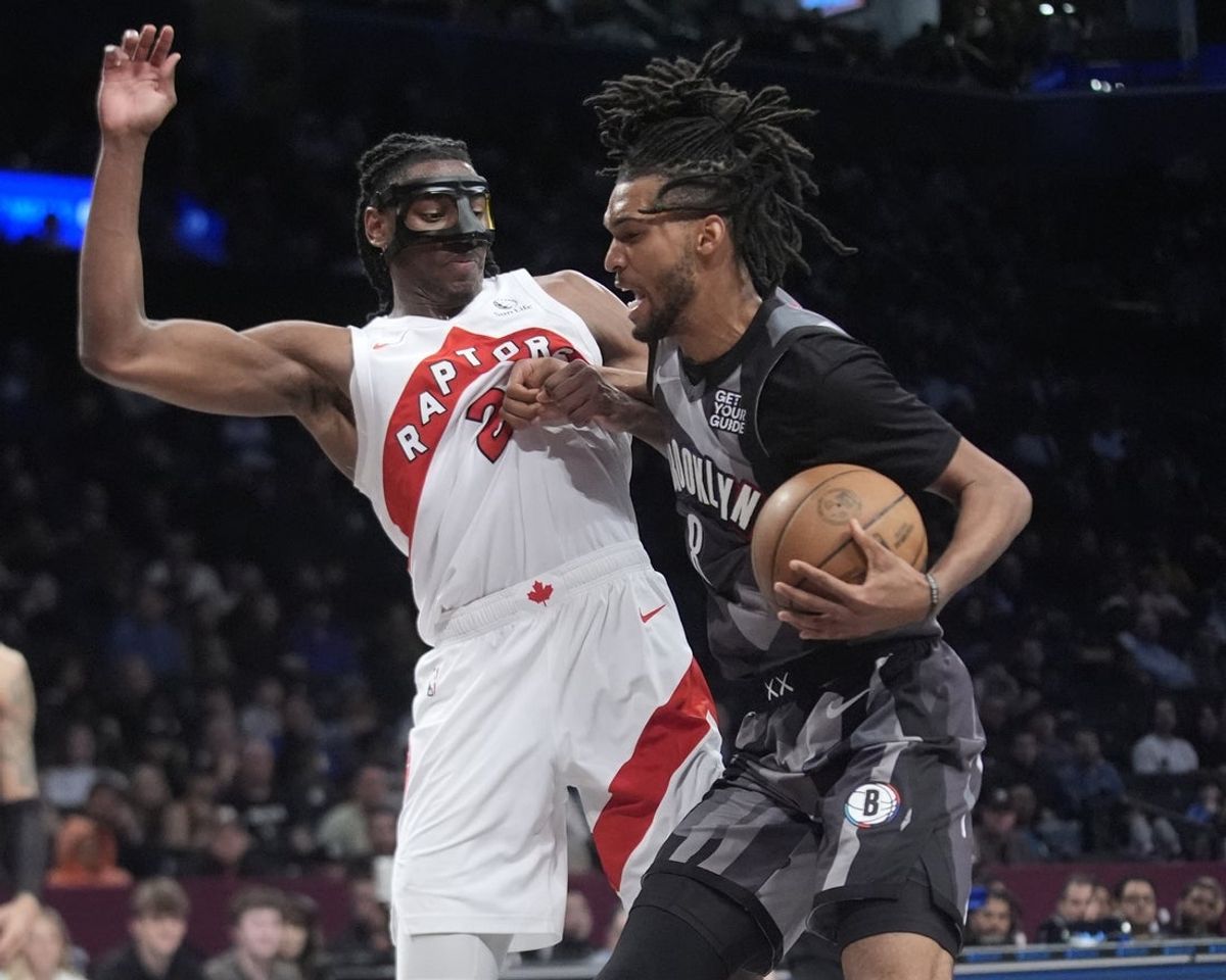 Apr 6, 2025; Brooklyn, New York, USA; Brooklyn Nets forward Ziaire Williams (8) drives the ball against Toronto Raptors forward Jonathan Mogbo (2) during the second half at Barclays Center. Mandatory Credit: Gregory Fisher-Imagn Images