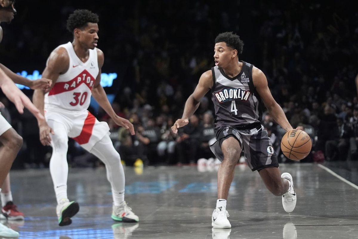 Apr 6, 2025; Brooklyn, New York, USA; Brooklyn Nets guard Reece Beekman (4) dribbles the ball against Toronto Raptors guard Ochai Agbaji (30) during the second half at Barclays Center. Mandatory Credit: Gregory Fisher-Imagn Images