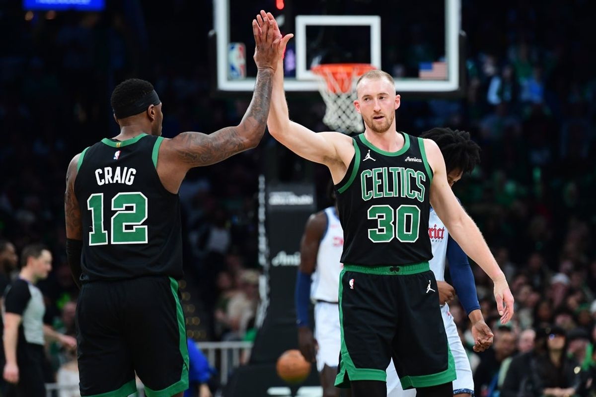 Apr 6, 2025; Boston, Massachusetts, USA; Boston Celtics forward Torrey Craig (12) high fives forward Sam Hauser (30) after a basket during the first half against the Washington Wizards at TD Garden. Mandatory Credit: Bob DeChiara-Imagn Images
