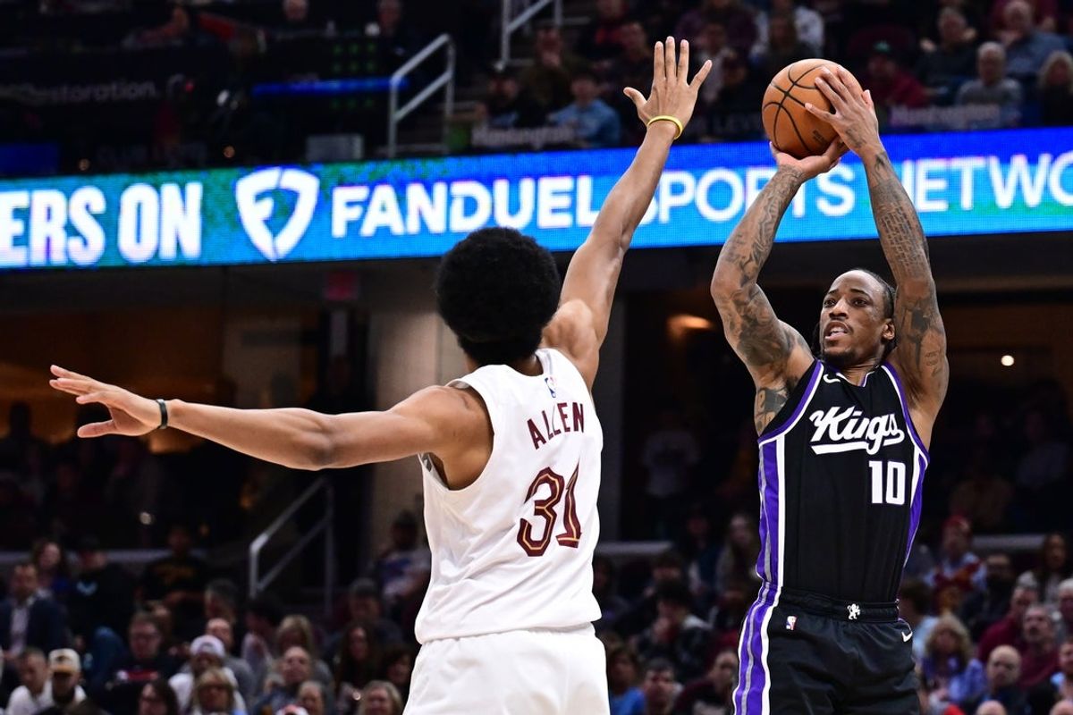 Apr 6, 2025; Cleveland, Ohio, USA; Sacramento Kings forward DeMar DeRozan (10) shoots over the defense of  Cleveland Cavaliers center Jarrett Allen (31) during the first half at Rocket Arena. Mandatory Credit: Ken Blaze-Imagn Images