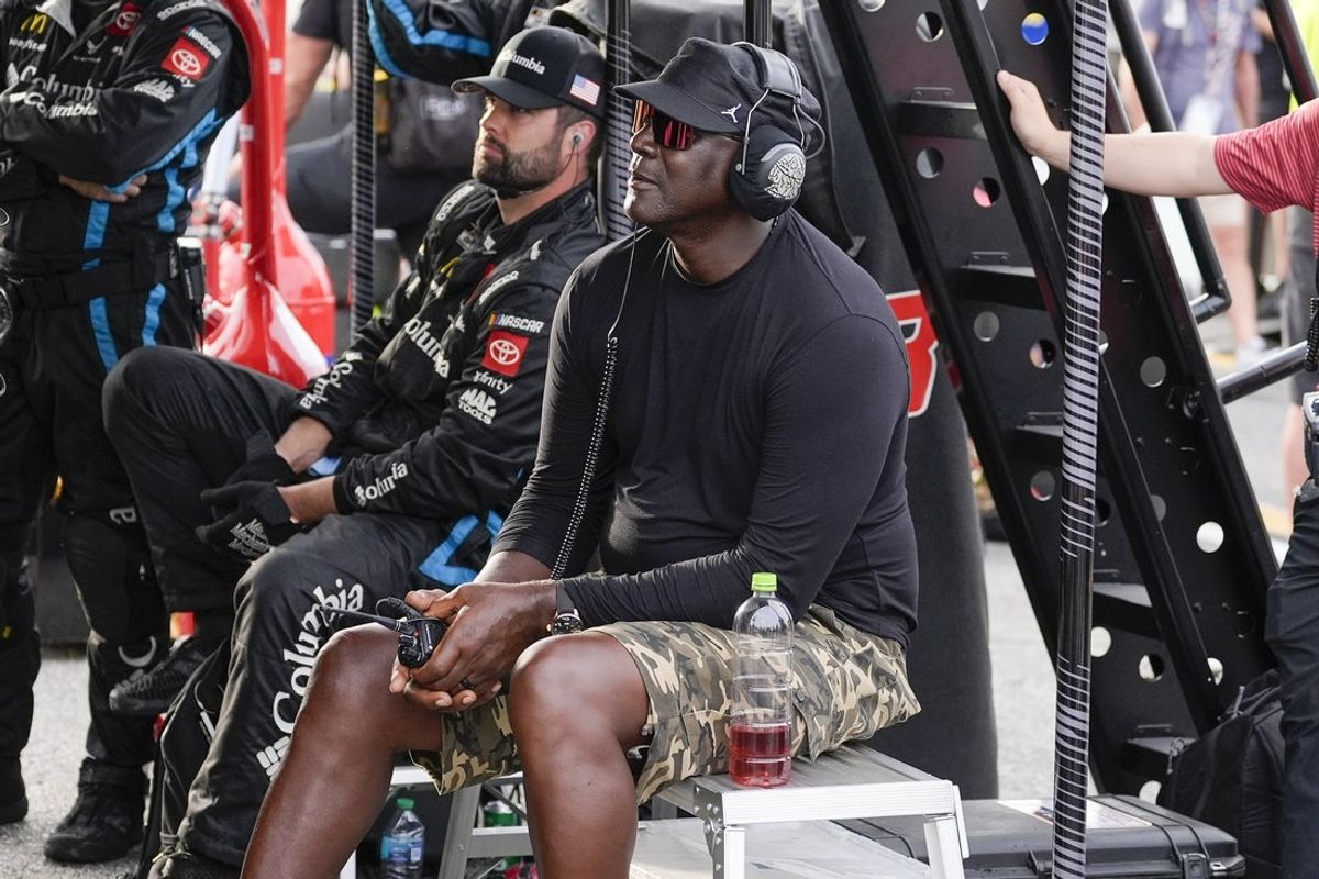 Apr 6, 2025; Darlington, South Carolina, USA; NASCAR Cup Series driver Tyler Reddick (45) team owner Michael Jordan watches his racer during the Goodyear 400 at Darlington Raceway. Mandatory Credit: Jim Dedmon-Imagn Images
