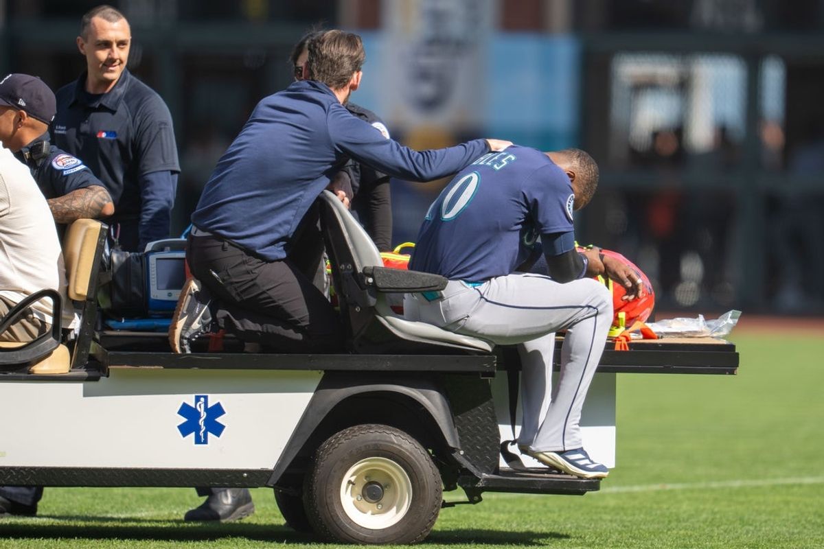 Apr 6, 2025; San Francisco, California, USA; Seattle Mariners right fielder Victor Robles (10) is injured during the play against the San Francisco Giants during the ninth inning attended medical personal at Oracle Park. Mandatory Credit: Neville E. Guard-Imagn Images