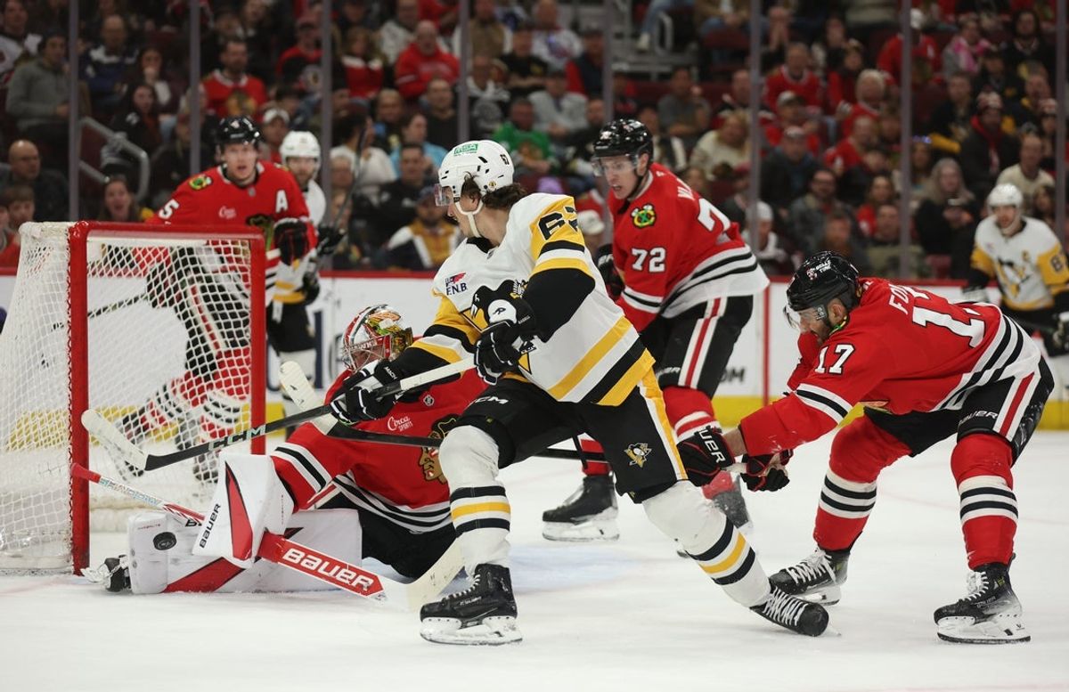 Apr 6, 2025; Chicago, Illinois, USA; Pittsburgh Penguins right wing Rickard Rakell (67) takes a shot on goal against Chicago Blackhawks goaltender Spencer Knight (30) during the second period at United Center. Mandatory Credit: Talia Sprague-Imagn Images