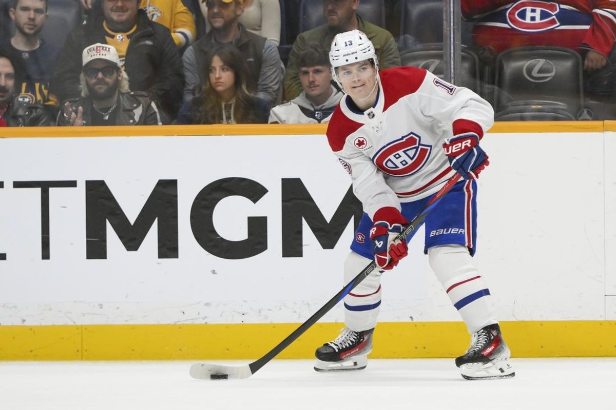 Apr 6, 2025; Nashville, Tennessee, USA; Montreal Canadiens right wing Cole Caufield (13) passes the puck against the Nashville Predators during the first period at Bridgestone Arena. Mandatory Credit: Steve Roberts-Imagn Images