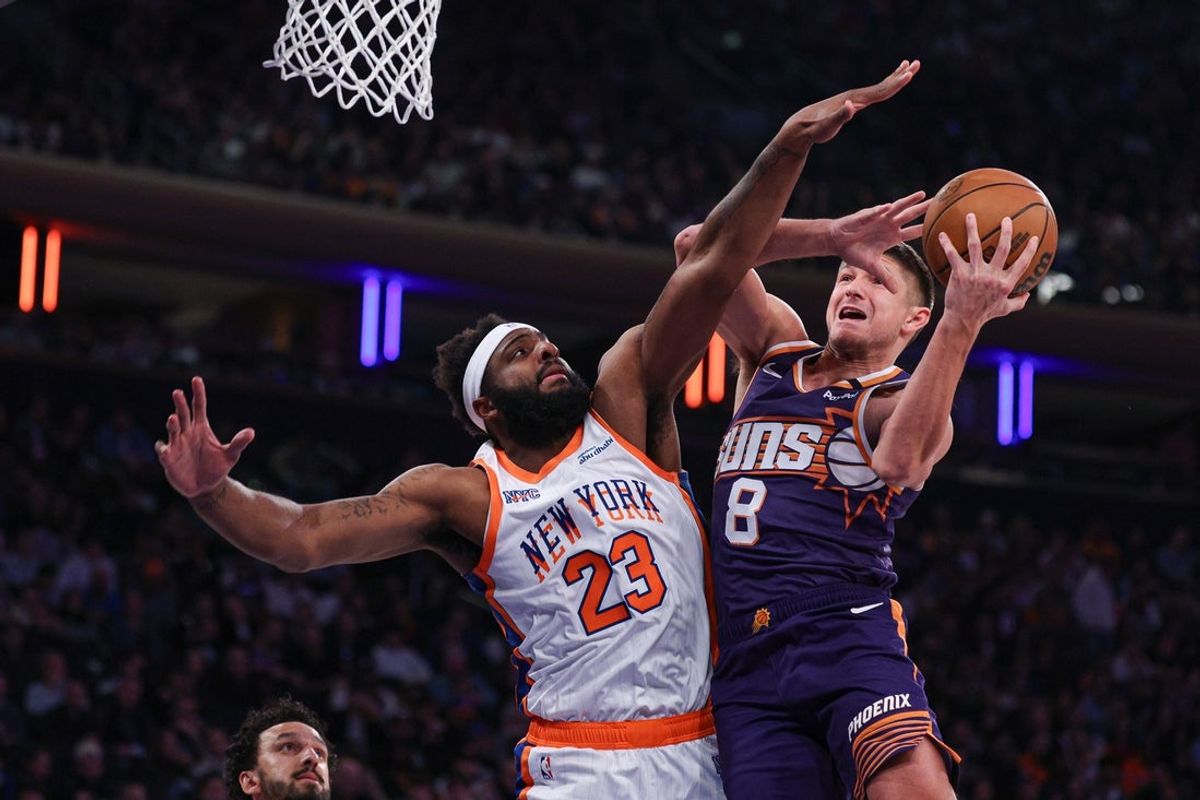 Apr 6, 2025; New York, New York, USA; Phoenix Suns guard Grayson Allen (8) goes to the basket against New York Knicks center Mitchell Robinson (23) during the first half at Madison Square Garden. Mandatory Credit: Vincent Carchietta-Imagn Images