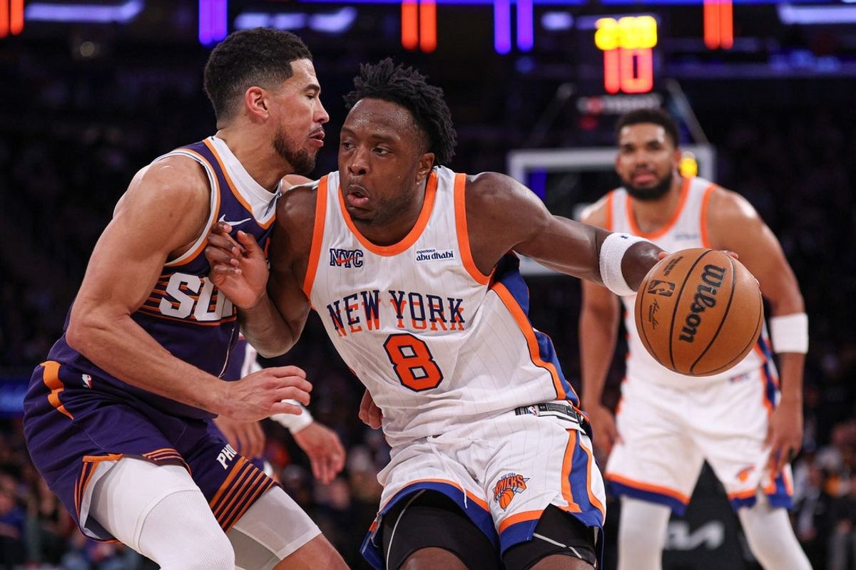 Apr 6, 2025; New York, New York, USA; New York Knicks forward OG Anunoby (8) dribbles against Phoenix Suns guard Devin Booker (1) during the second half at Madison Square Garden. Mandatory Credit: Vincent Carchietta-Imagn Images