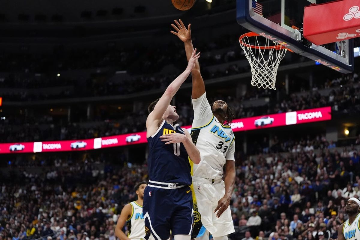 Apr 6, 2025; Denver, Colorado, USA; Indiana Pacers center Myles Turner (33) defends on Denver Nuggets guard Christian Braun (0) in the second half at Ball Arena. Mandatory Credit: Ron Chenoy-Imagn Images