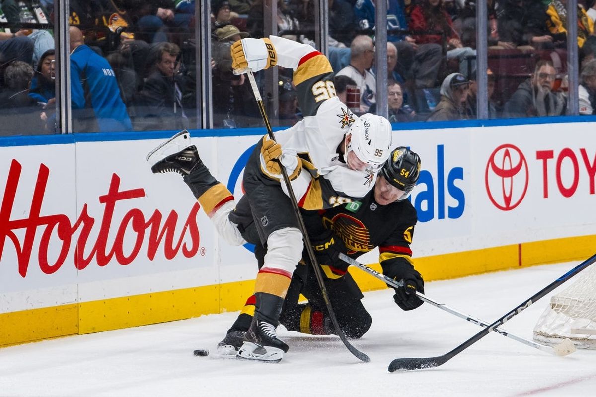Apr 6, 2025; Vancouver, British Columbia, CAN; Vegas Golden Knights forward Victor Olofsson (95) battles with Vancouver Canucks forward Aatu Raty (54) in the first period at Rogers Arena. Mandatory Credit: Bob Frid-Imagn Images
