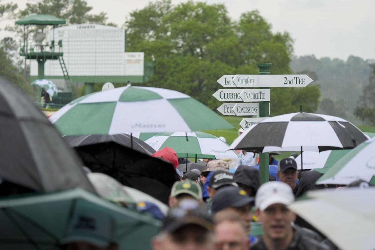 Apr 7, 2025; Augusta, Georgia, USA; Patrons leave the course as inclement weather suspends play during a practice round of the Masters Tournament at Augusta National Golf Club. Mandatory Credit: Katie Goodale-Imagn Images