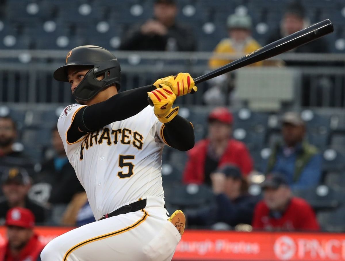 Apr 7, 2025; Pittsburgh, Pennsylvania, USA;  Pittsburgh Pirates first baseman Endy Rodriguez (5) hits a double against the St. Louis Cardinals during the second inning at PNC Park. Mandatory Credit: Charles LeClaire-Imagn Images