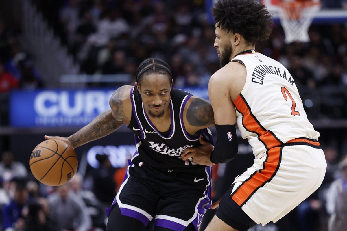 Apr 7, 2025; Detroit, Michigan, USA;  Sacramento Kings forward DeMar DeRozan (10) dribbles defended by Detroit Pistons guard Cade Cunningham (2) in the first half at Little Caesars Arena. Mandatory Credit: Rick Osentoski-Imagn Images