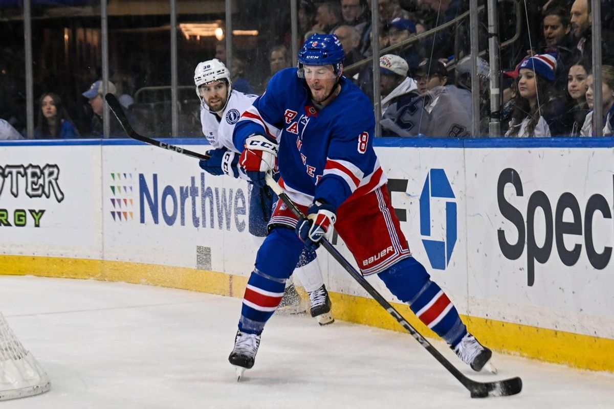 Apr 7, 2025; New York, New York, USA;  New York Rangers left wing J.T. Miller (8) plays the puck from behind the net against the Tampa Bay Lightning during the second period at Madison Square Garden. Mandatory Credit: Dennis Schneidler-Imagn Images