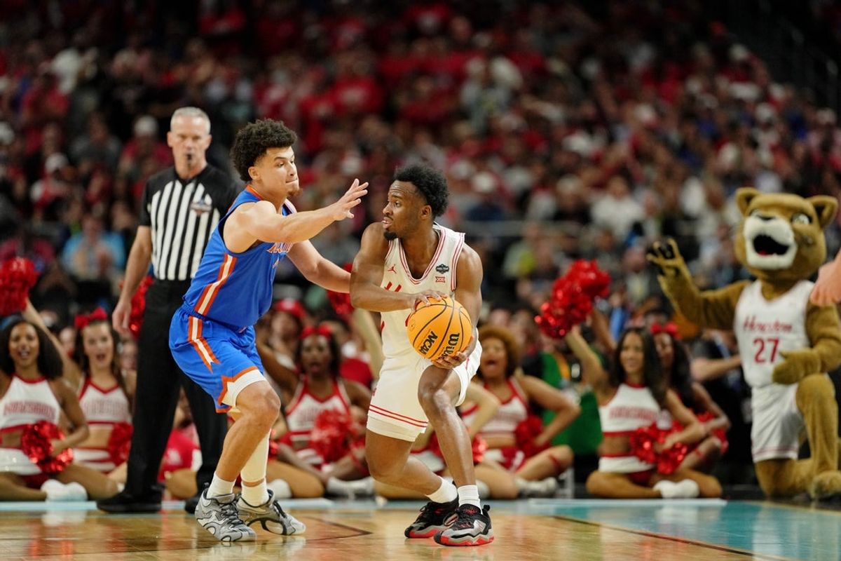 Apr 7, 2025; San Antonio, TX, USA; Houston Cougars guard L.J. Cryer (4) controls the ball against Florida Gators guard Walter Clayton Jr. (1) during the second half of the national championship game of the Final Four of the 2025 NCAA Tournament at the Alamodome. Mandatory Credit: Bob Donnan-Imagn Images