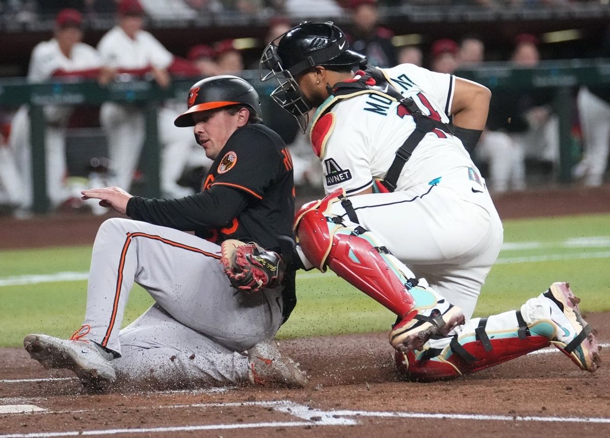 Arizona Diamondbacks catcher Gabriel Moreno (14) tags out Baltimore Orioles Adley Rutschman (35) at home plate during their game at Chase Field on April 7, 2025.