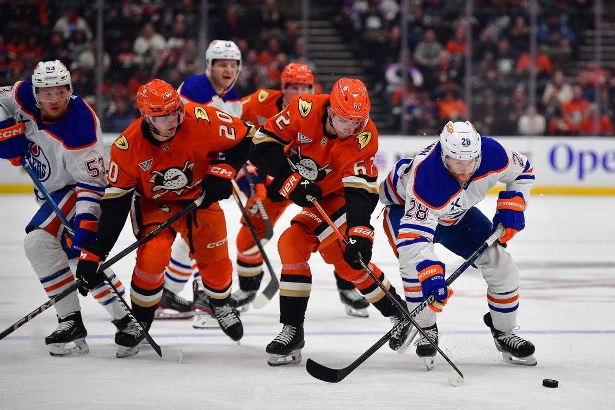 Apr 7, 2025; Anaheim, California, USA; Anaheim Ducks center Nikita Nesterenko (62) plays for the puck against Edmonton Oilers right wing Connor Brown (28) during the second period at Honda Center. Mandatory Credit: Gary A. Vasquez-Imagn Images