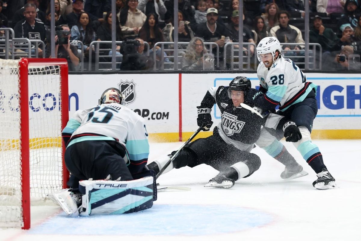 Apr 7, 2025; Los Angeles, California, USA;  Los Angeles Kings left wing Jeff Malott (39) skates with the puck as Seattle Kraken defenseman Joshua Mahura (28) defends during the second period at Crypto.com Arena. Mandatory Credit: Kiyoshi Mio-Imagn Images