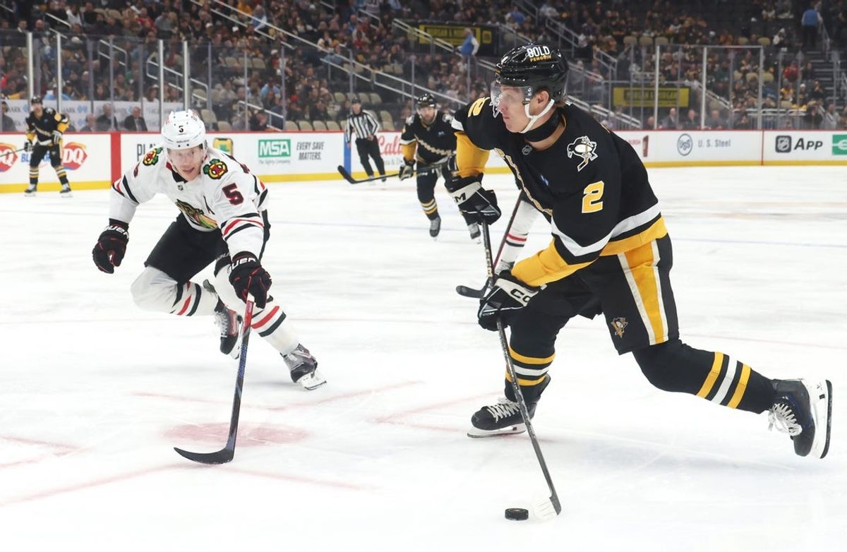 Apr 8, 2025; Pittsburgh, Pennsylvania, USA;  Pittsburgh Penguins right wing Rutger McGroarty (2) shoots the puck as Chicago Blackhawks defenseman Connor Murphy (5) defends during the first period at PPG Paints Arena. Mandatory Credit: Charles LeClaire-Imagn Images