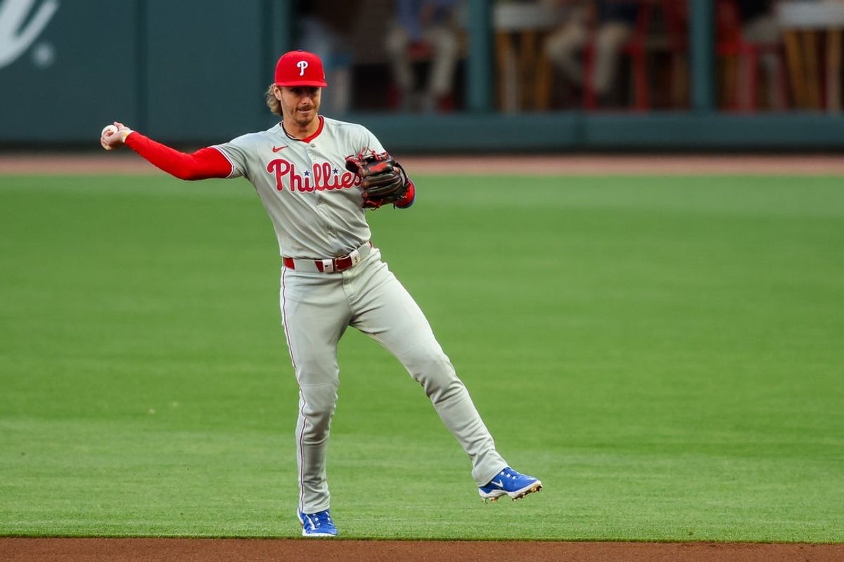 Apr 8, 2025; Atlanta, Georgia, USA; Philadelphia Phillies second baseman Bryson Stott (5) throws a runner out at first against the Atlanta Braves in the first inning at Truist Park. Mandatory Credit: Brett Davis-Imagn Images