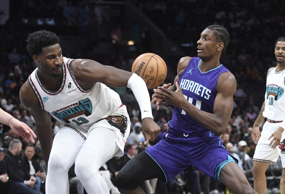 Apr 8, 2025; Charlotte, North Carolina, USA;  Charlotte Hornets center Moussa Diabate (14) gets the ball stripped by Memphis Grizzlies forward center Jaren Jackson Jr. (13) during the first half at the Spectrum Center. Mandatory Credit: Sam Sharpe-Imagn Images
