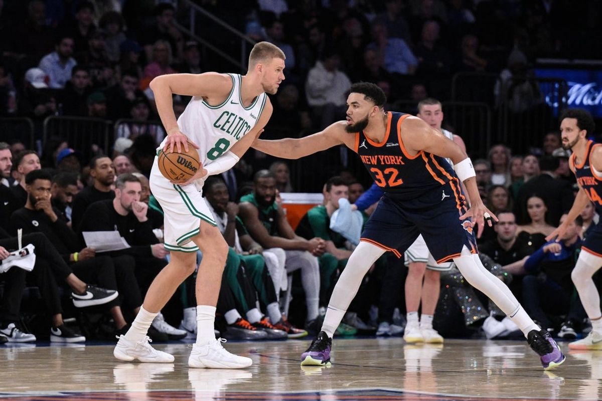 Apr 8, 2025; New York, New York, USA; Boston Celtics center Kristaps Porzingis (8) looks for an opening against New York Knicks center Karl-Anthony Towns (32) during the first half at Madison Square Garden. Mandatory Credit: John Jones-Imagn Images