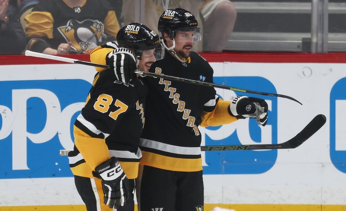 Apr 8, 2025; Pittsburgh, Pennsylvania, USA;  Pittsburgh Penguins center Sidney Crosby (87) congratulates defenseman Erik Karlsson (65) on his 200th career NHL goal against the Chicago Blackhawks during the second period at PPG Paints Arena. Mandatory Credit: Charles LeClaire-Imagn Images