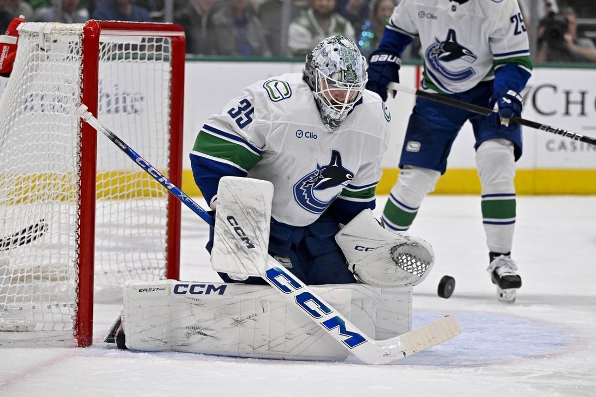 Apr 8, 2025; Dallas, Texas, USA; Vancouver Canucks goaltender Thatcher Demko (35) makes a save on a Dallas Stars shot during the second period at the American Airlines Center. Mandatory Credit: Jerome Miron-Imagn Images