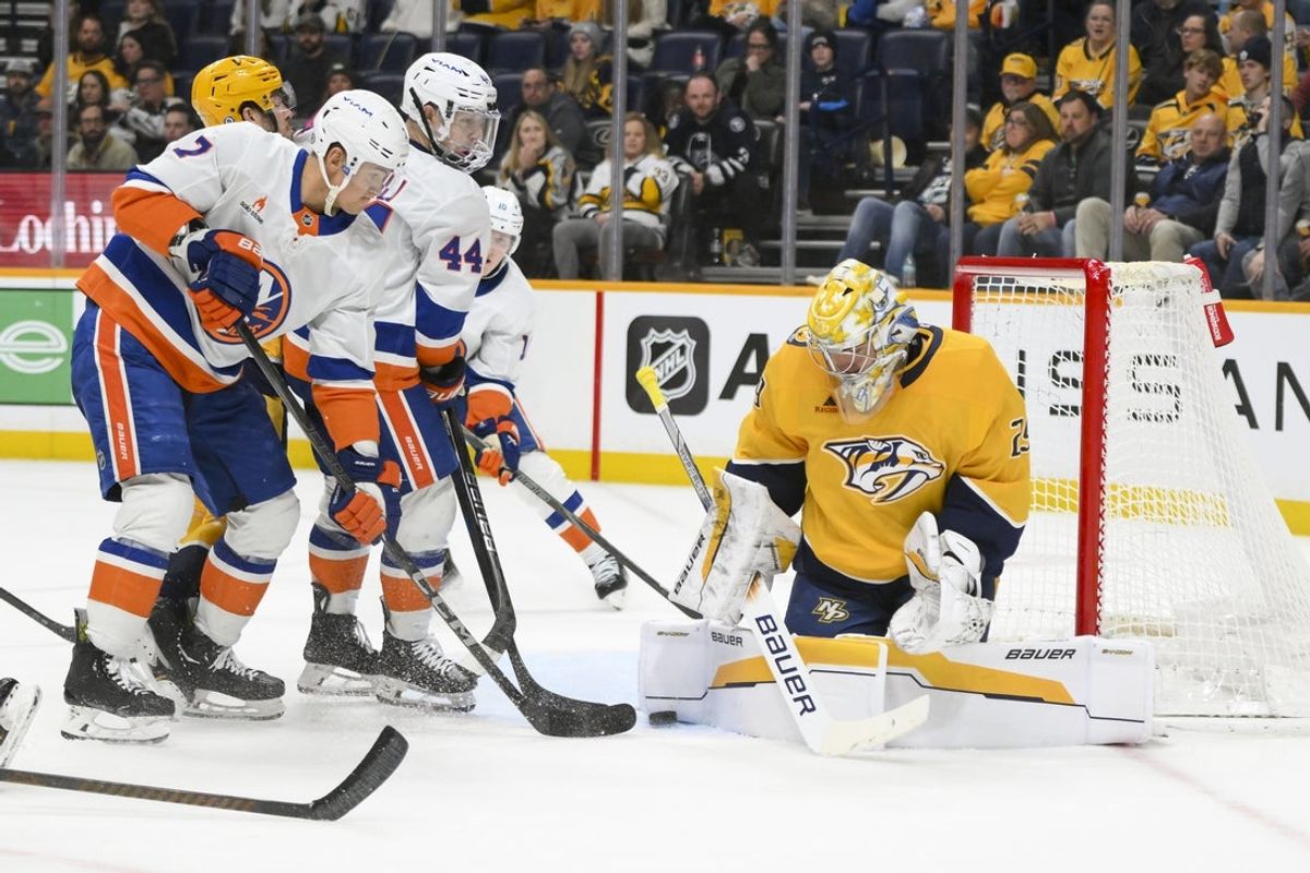 Apr 8, 2025; Nashville, Tennessee, USA;  Nashville Predators goaltender Justus Annunen (29) blocks the shot of New York Islanders right wing Maxim Tsyplakov (7) during the second period at Bridgestone Arena. Mandatory Credit: Steve Roberts-Imagn Images