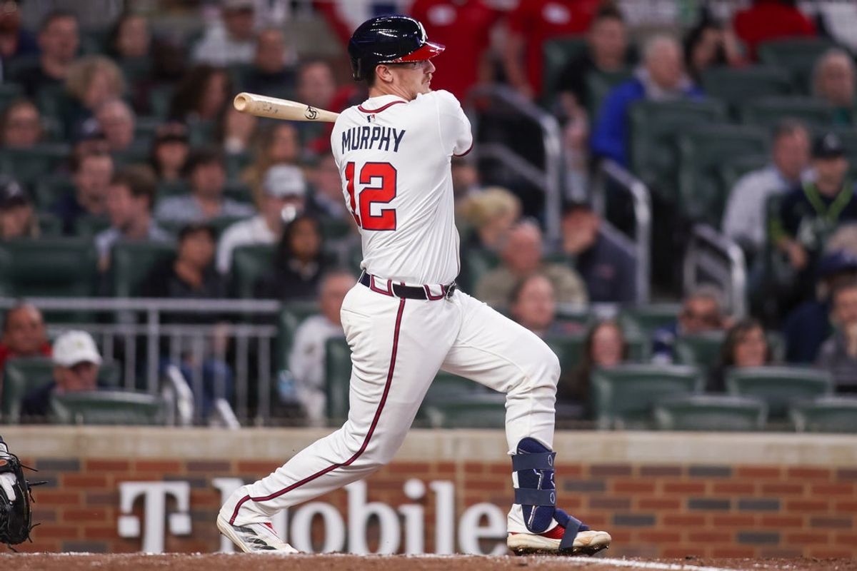 Apr 8, 2025; Atlanta, Georgia, USA; Atlanta Braves catcher Sean Murphy (12) hits a RBI single against the Philadelphia Phillies in the sixth inning at Truist Park. Mandatory Credit: Brett Davis-Imagn Images