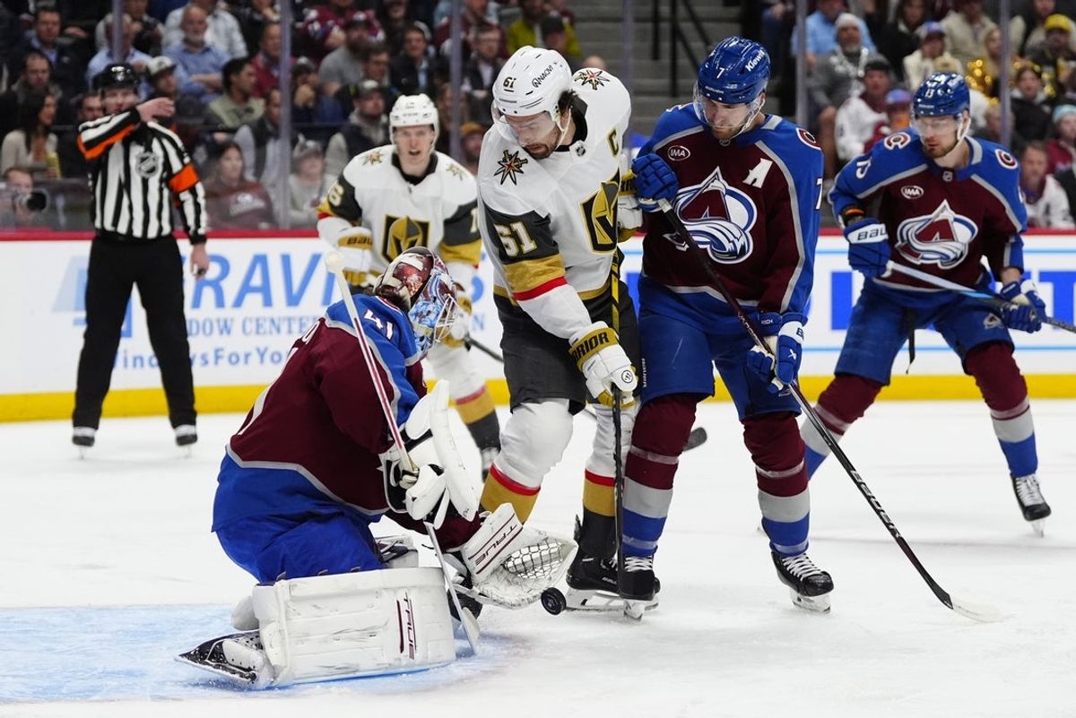 Apr 8, 2025; Denver, Colorado, USA; Vegas Golden Knights right wing Mark Stone (61) redirects the puck at Colorado Avalanche goaltender Scott Wedgewood (41) as defenseman Devon Toews (7) defends in the first period at Ball Arena. Mandatory Credit: Ron Chenoy-Imagn Images