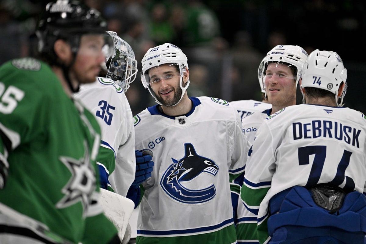 Apr 8, 2025; Dallas, Texas, USA; Vancouver Canucks goaltender Thatcher Demko (35) and center Max Sasson (63) and right wing Brock Boeser (6) and left wing Jake DeBrusk (74) celebrate the victory over the Dallas Stars at the American Airlines Center. Mandatory Credit: Jerome Miron-Imagn Images
