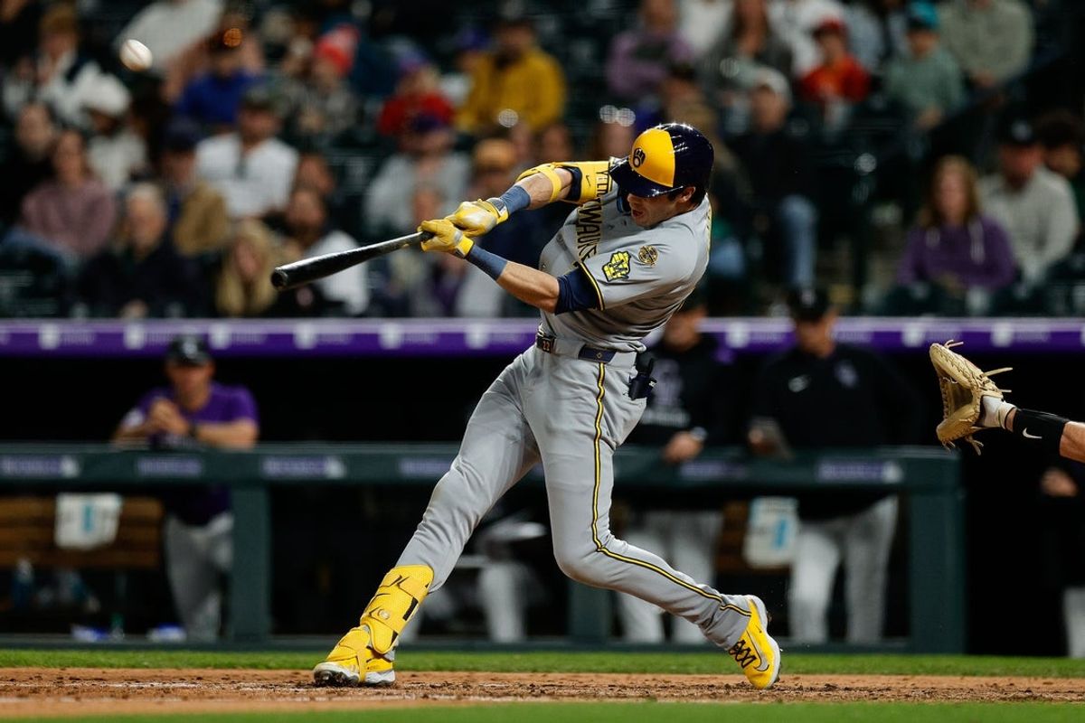 Apr 8, 2025; Denver, Colorado, USA; Milwaukee Brewers designated hitter Christian Yelich (22) hits a solo home run in the seventh inning against the Colorado Rockies at Coors Field. Mandatory Credit: Isaiah J. Downing-Imagn Images
