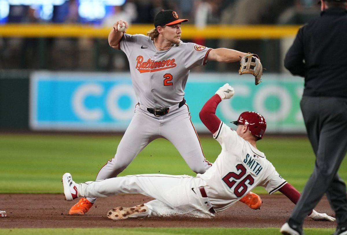 Baltimore Orioles infielder Gunnar Henderson (2) throws over Arizona Diamondbacks' Pavin Smith (26) for the double play at Chase Field in Phoenix on April 8, 2025.