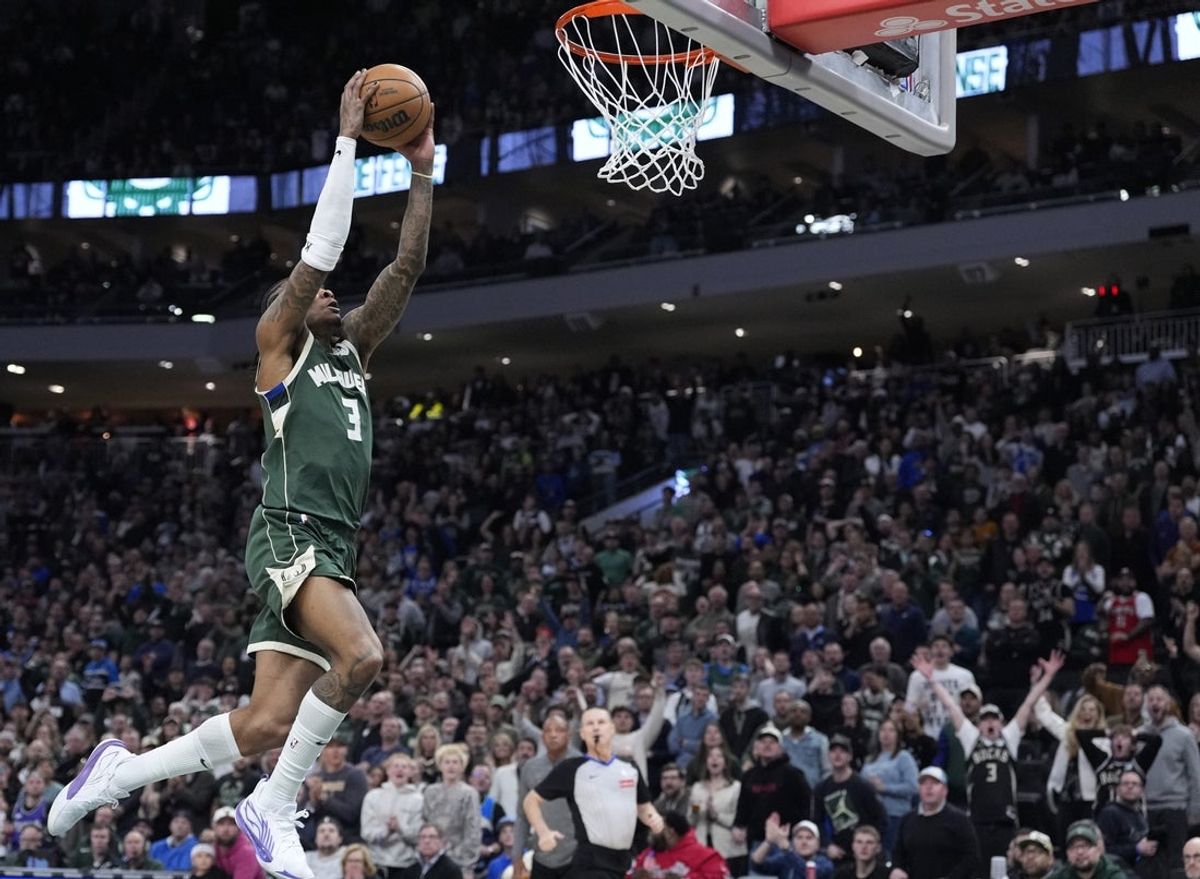 Apr 8, 2025; Milwaukee, Wisconsin, USA; Milwaukee Bucks guard Kevin Porter Jr. (3) dunks the ball against the Minnesota Timberwolves in the second half at Fiserv Forum. Mandatory Credit: Michael McLoone-Imagn Images