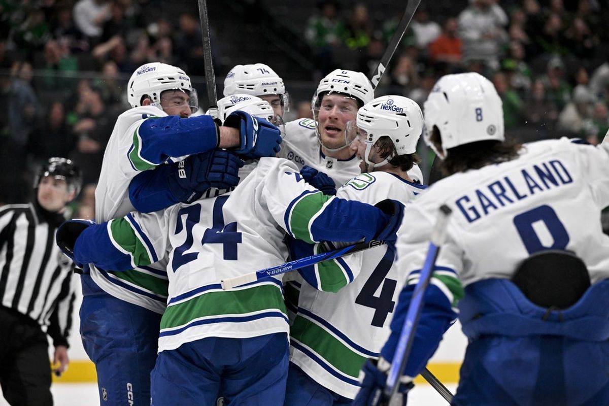 Apr 8, 2025; Dallas, Texas, USA; Vancouver Canucks left wing Jake DeBrusk (74) and center Pius Suter (24) and right wing Brock Boeser (6) and right wing Conor Garland (8) and defenseman Filip Hronek (17) and defenseman Quinn Hughes (43) celebrates the game tying goal scored by Suter against the Dallas Stars during the third period at the American Airlines Center. Mandatory Credit: Jerome Miron-Imagn Images