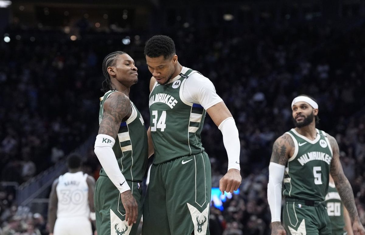 Apr 8, 2025; Milwaukee, Wisconsin, USA; Milwaukee Bucks guard Kevin Porter Jr. (3) and Milwaukee Bucks forward Giannis Antetokounmpo (34) celebrate as the clock winds down in their 110-103 comeback victory over the Minnesota Timberwolves at Fiserv Forum. Mandatory Credit: Michael McLoone-Imagn Images